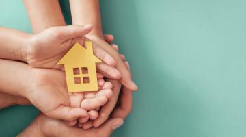 image of hands holding a house