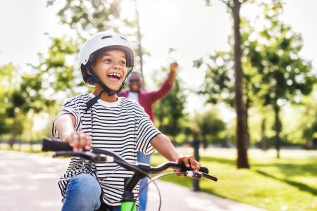 Boy rides on bike in safe neighbourhood