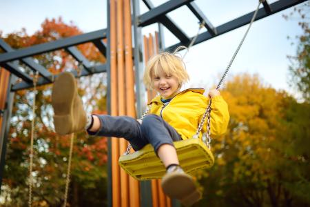 Child plays on a swing